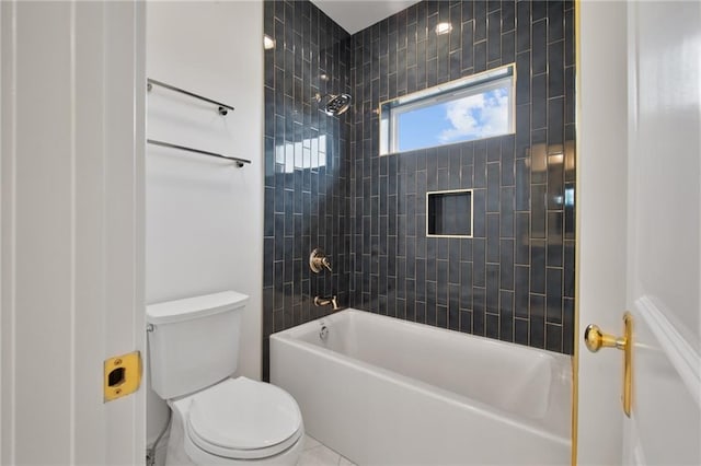 bathroom featuring toilet and tiled shower / bath combo