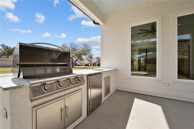 view of patio / terrace featuring an outdoor kitchen, sink, and a grill