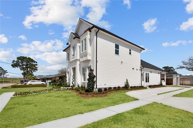 view of property exterior featuring a lawn