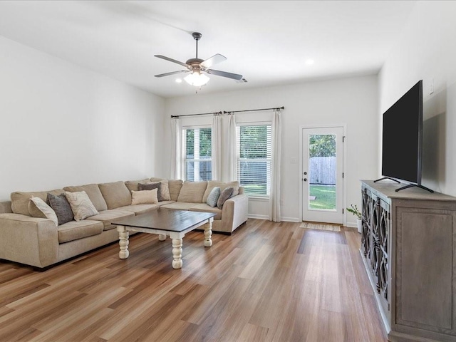 living room with light hardwood / wood-style floors and ceiling fan