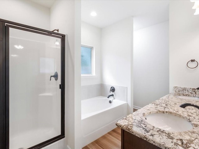 bathroom featuring vanity, separate shower and tub, and hardwood / wood-style floors