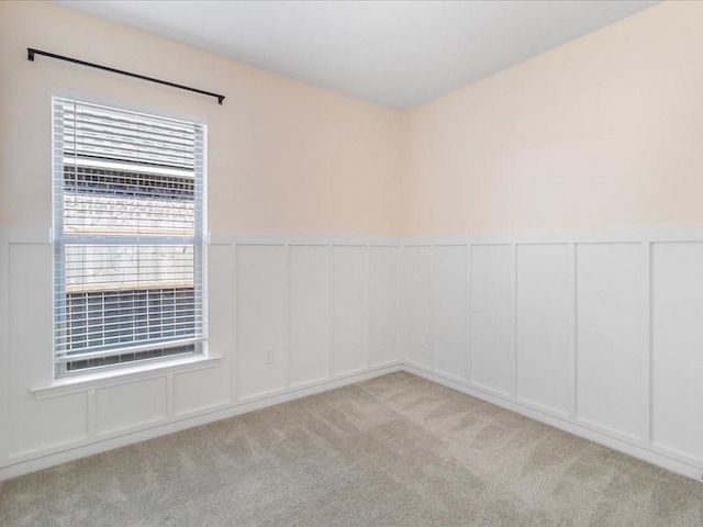 spare room with light colored carpet