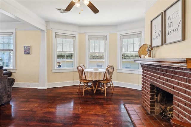 2724 Clover St, New Orleans, LA 70122 - dining area featuring baseboards, a ceiling fan, a brick fireplace, and wood finished floors