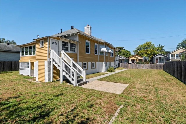 2724 Clover St, New Orleans, LA 70122 - back of property with a chimney, stairway, and a residential view