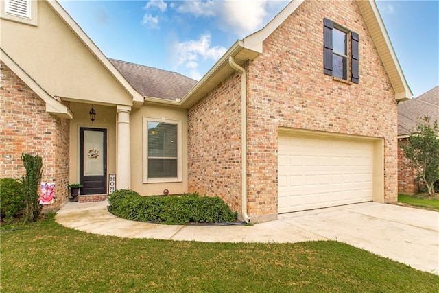 view of front of house featuring a garage and a front lawn