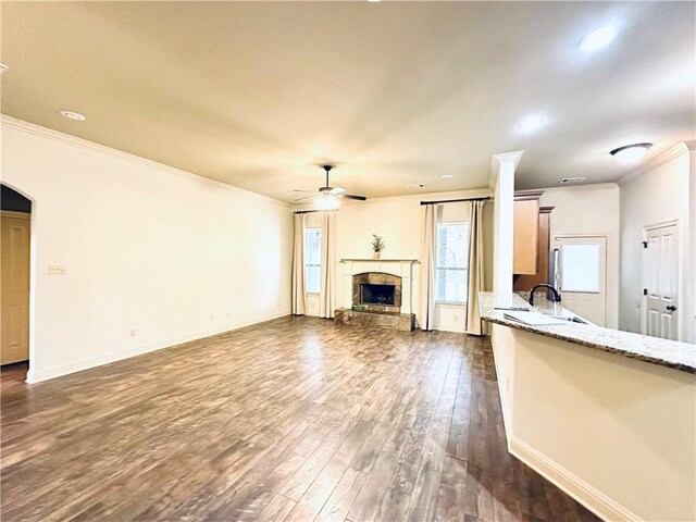 living room featuring ornate columns, ceiling fan, hardwood / wood-style flooring, and crown molding