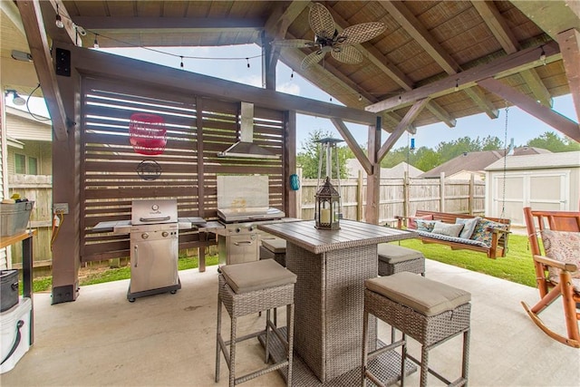 view of patio / terrace with a storage unit, an outdoor living space, and ceiling fan