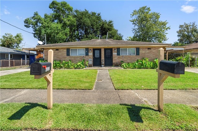 ranch-style home with a front lawn and a carport