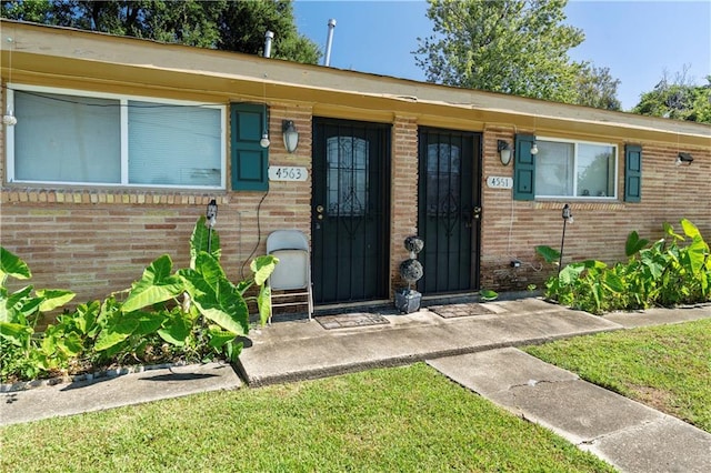 doorway to property featuring a yard