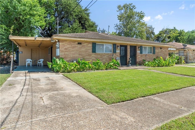 single story home with a front lawn and a carport