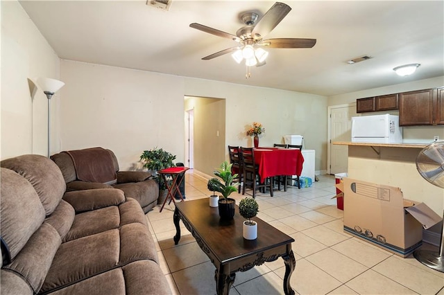 tiled living room with ceiling fan