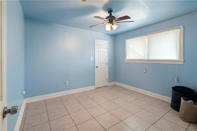 tiled empty room with ceiling fan