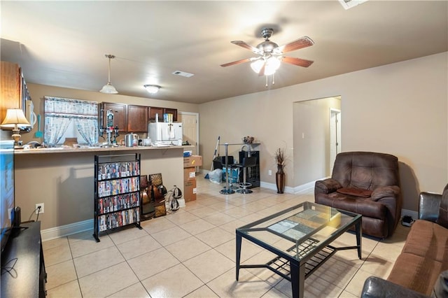 living room featuring ceiling fan and light tile patterned floors