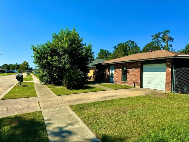 view of front facade with a front yard and a garage