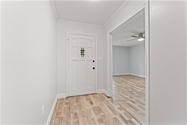 foyer featuring ceiling fan, a textured ceiling, crown molding, and light hardwood / wood-style floors