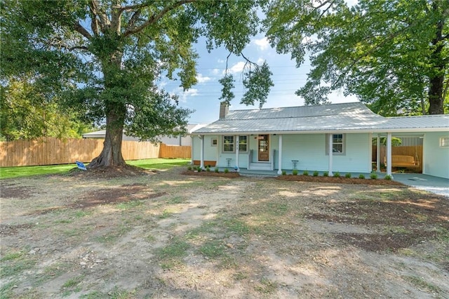 view of front of house with a porch and a carport