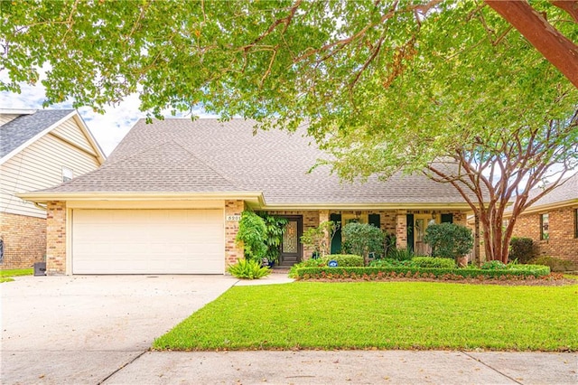 view of front of home with a garage and a front yard