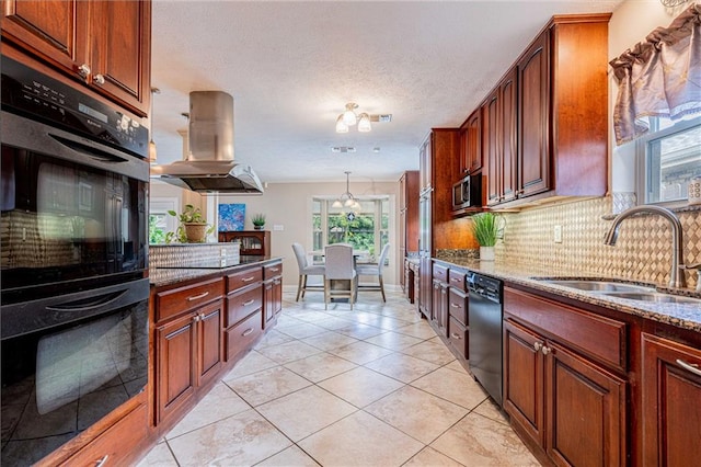 kitchen featuring sink, stone countertops, island range hood, black appliances, and decorative backsplash