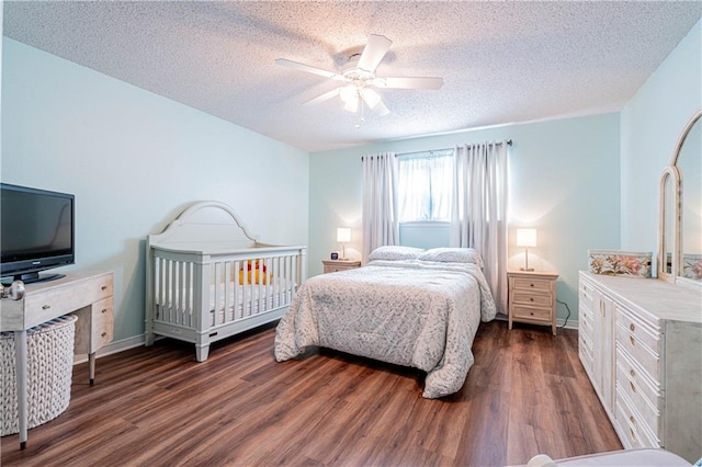 bedroom featuring a textured ceiling, ceiling fan, and dark wood-type flooring