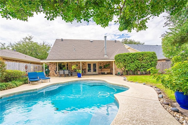 view of swimming pool featuring a patio area and french doors