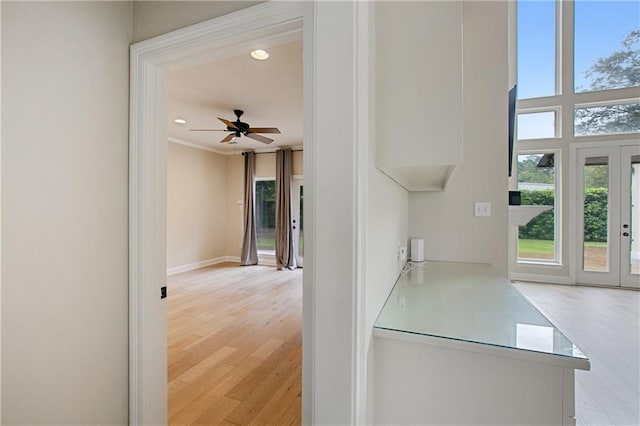 hall featuring ornamental molding, french doors, and light hardwood / wood-style flooring