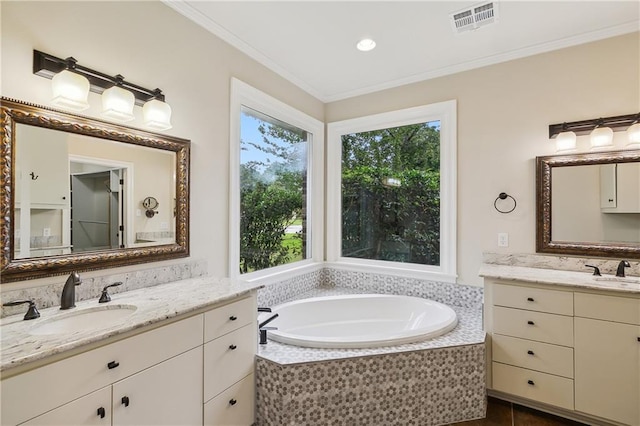 bathroom with vanity, crown molding, a relaxing tiled tub, and tile patterned flooring