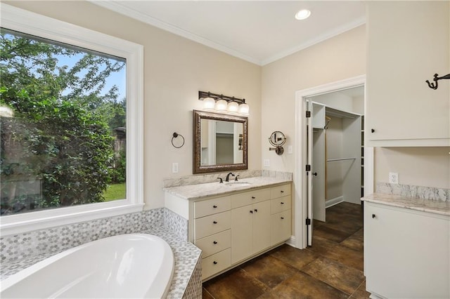 bathroom with vanity, a tub to relax in, and crown molding