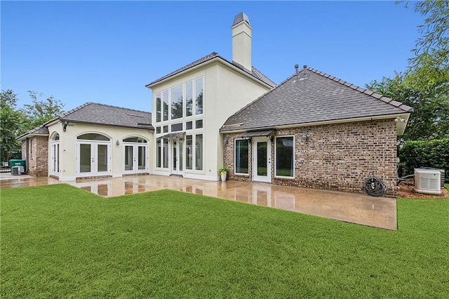 rear view of property with a patio and a yard