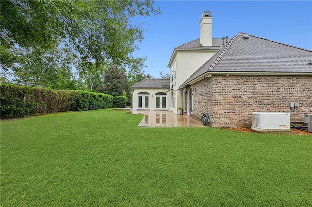 view of yard with a patio area and central AC