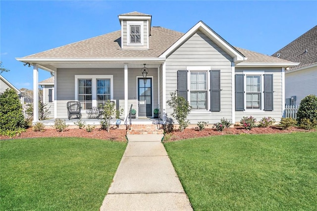 view of front of home with a front yard and a porch