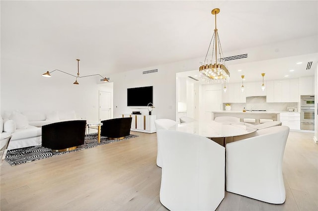 dining area featuring light wood-type flooring