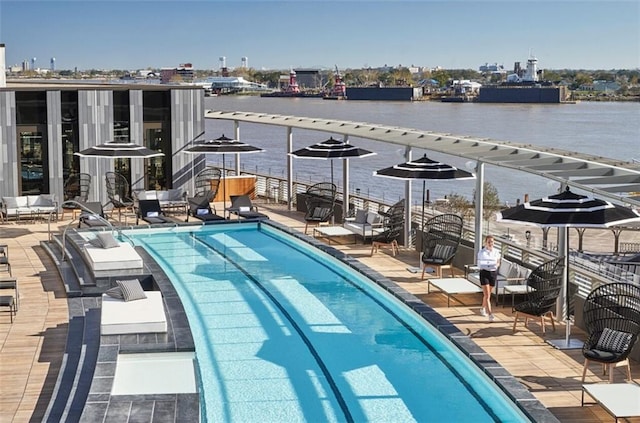 view of swimming pool featuring a water view