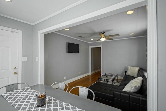 living room with ceiling fan, hardwood / wood-style flooring, and crown molding