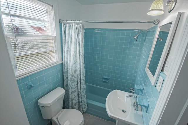 bathroom featuring tile walls, toilet, shower / bathtub combination with curtain, and tile patterned floors