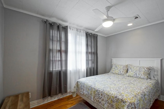 bedroom featuring crown molding, hardwood / wood-style floors, and ceiling fan