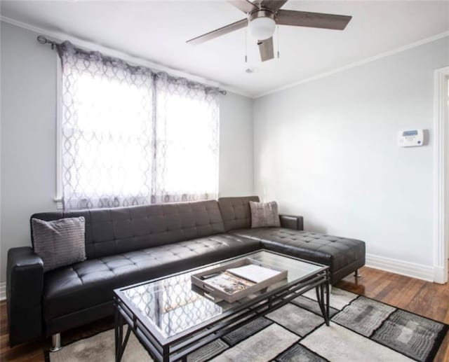 living room featuring wood-type flooring, ornamental molding, and ceiling fan