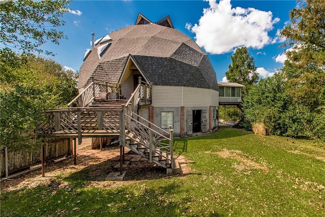 rear view of house featuring a lawn