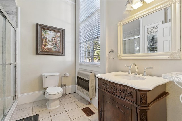 bathroom with heating unit, tile patterned flooring, walk in shower, vanity, and toilet