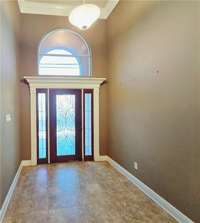 entryway featuring crown molding