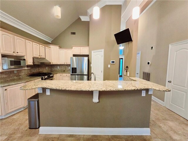 kitchen featuring light stone countertops, pendant lighting, appliances with stainless steel finishes, tasteful backsplash, and high vaulted ceiling