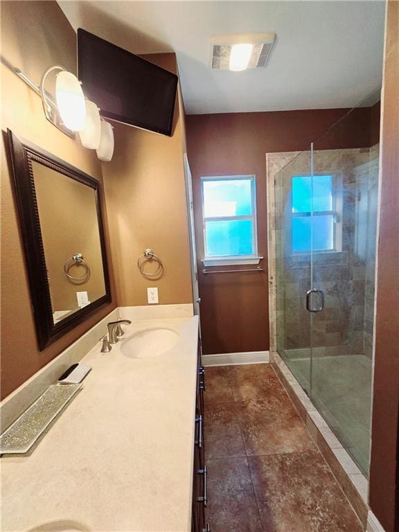 bathroom with a shower with shower door and vanity