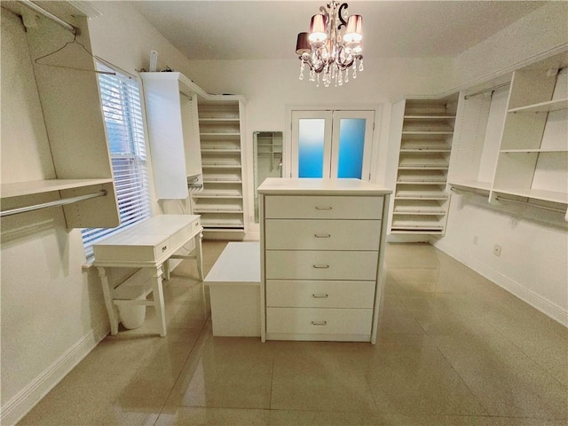 spacious closet with a chandelier