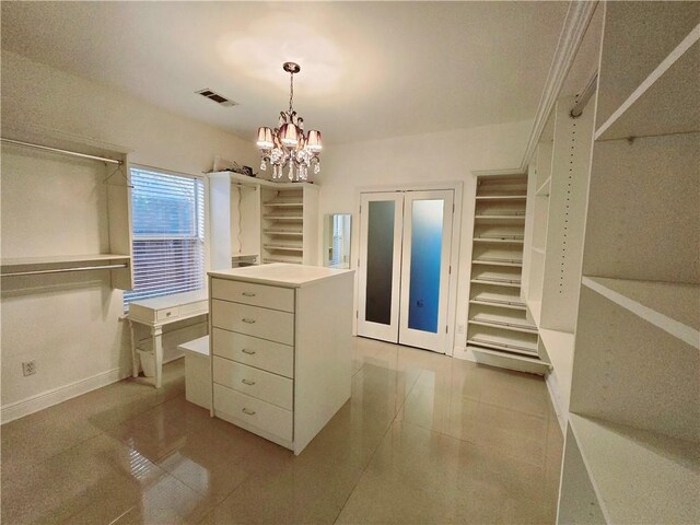 walk in closet with a chandelier