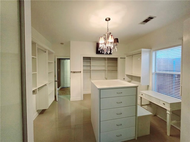 spacious closet featuring a chandelier