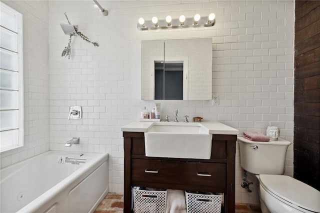 full bathroom with tiled shower / bath, vanity, tile walls, and toilet