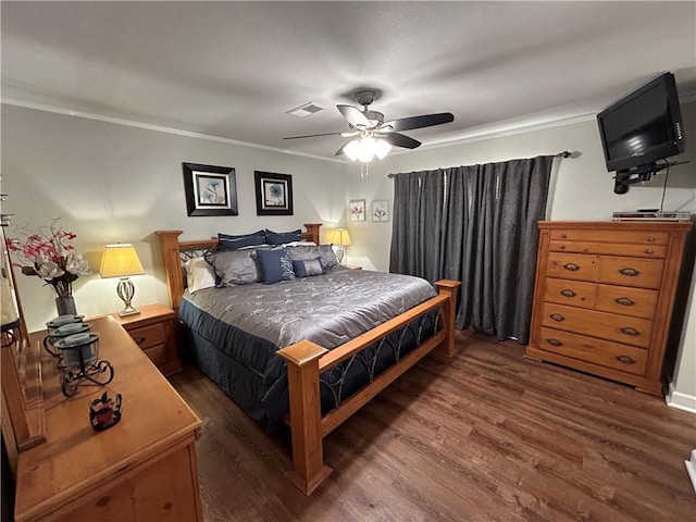 bedroom featuring ceiling fan, dark hardwood / wood-style flooring, and ornamental molding