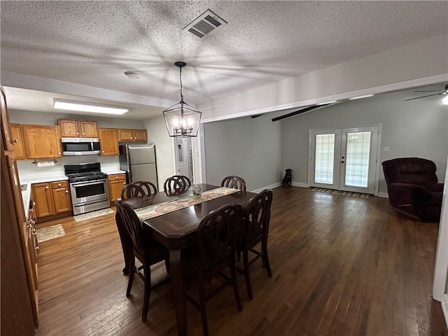 empty room with ceiling fan, a textured ceiling, dark hardwood / wood-style floors, and ornamental molding