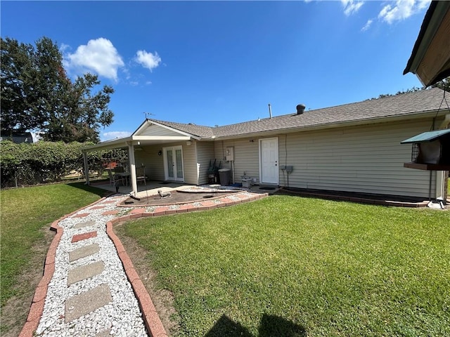 back of property featuring a lawn, french doors, and a patio