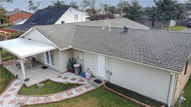 back of house featuring a patio area and a lawn