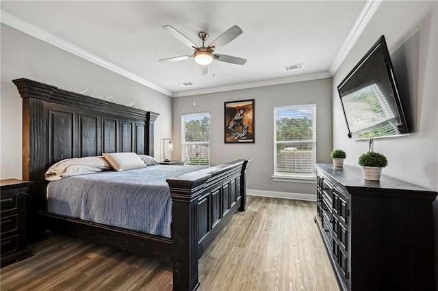 bedroom with ornamental molding, hardwood / wood-style flooring, and ceiling fan